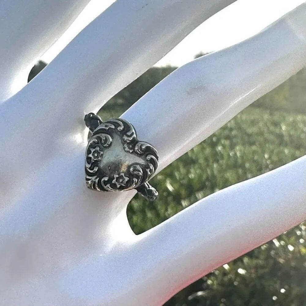 Silver tone heart ring on cord